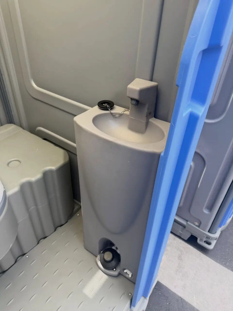 Foot-pump sink inside a porta potty