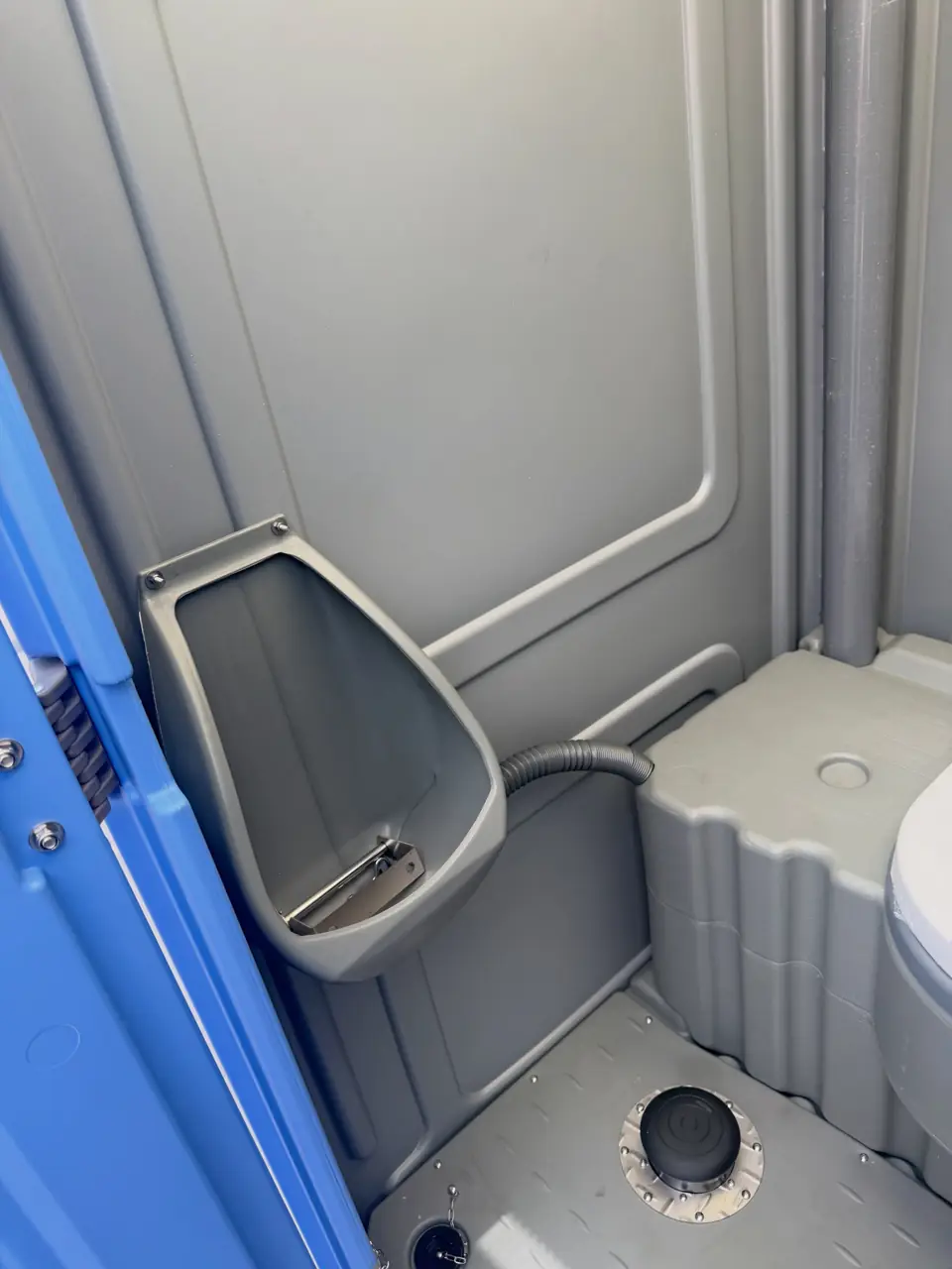 Urinal inside a standard porta potty